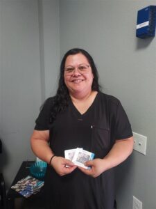 A smiling woman in a black shirt.