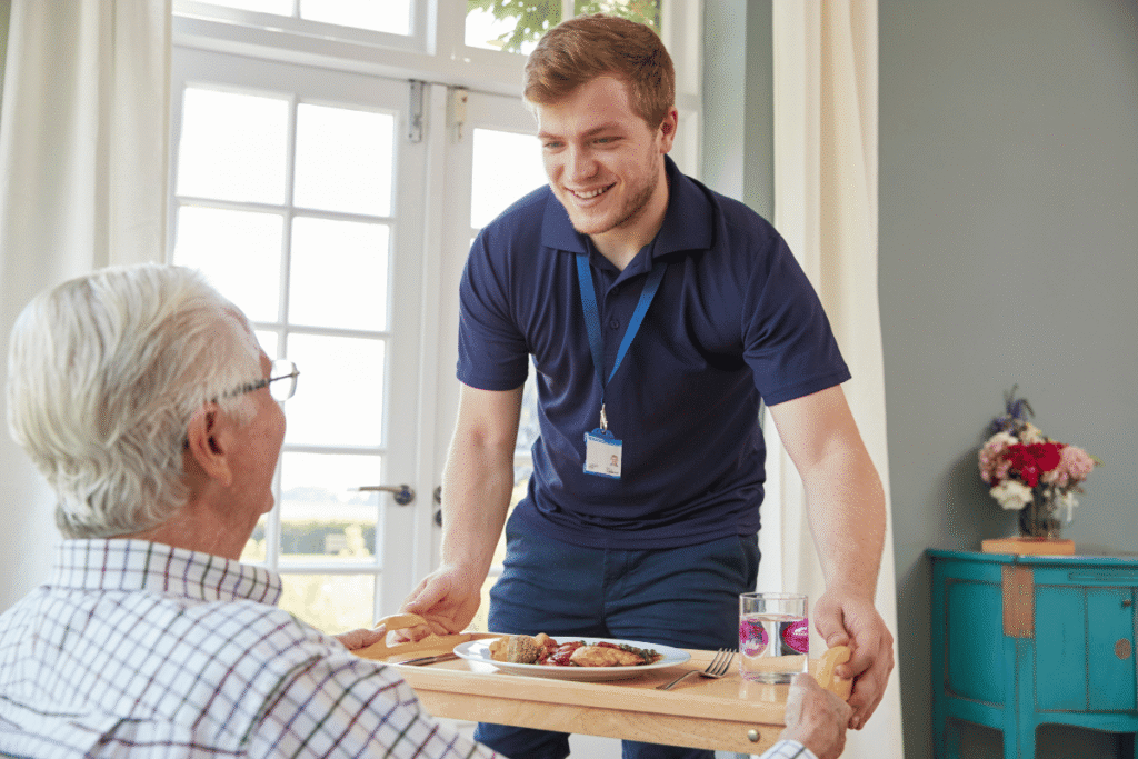 A young man assisting an elderly man