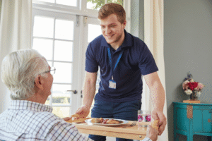 A young man assisting an elderly man